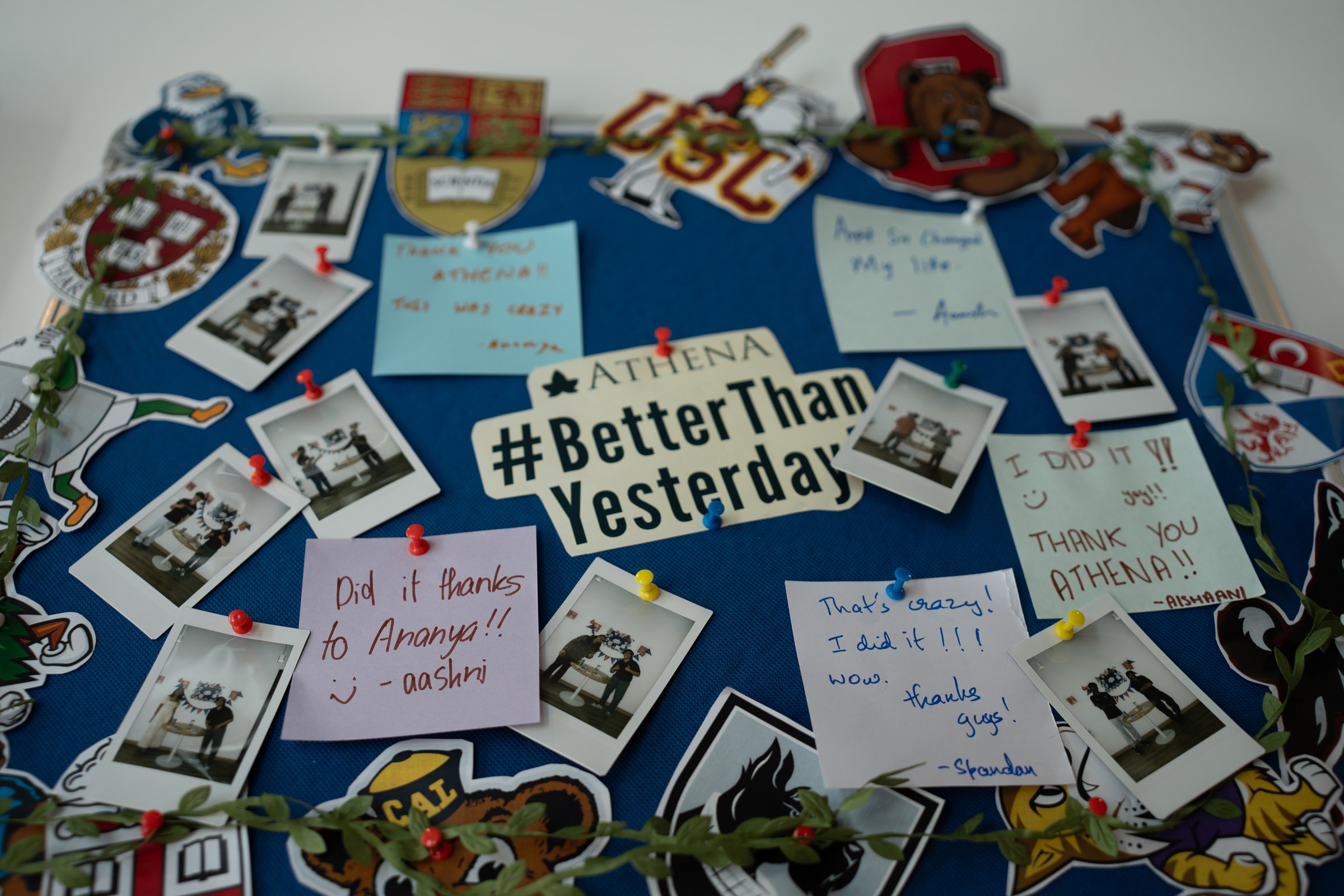 Athena achievement board with student notes and college logos